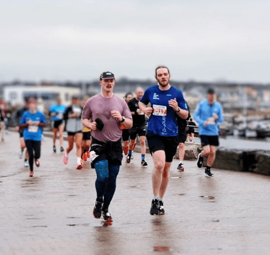Enhance-d club members running together at an event